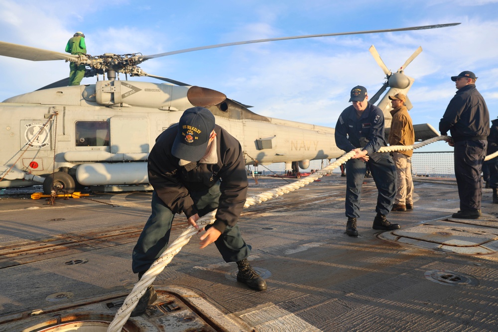 Sailors prepare the flight deck for a sea-and-anchor evolution