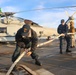 Sailors prepare the flight deck for a sea-and-anchor evolution