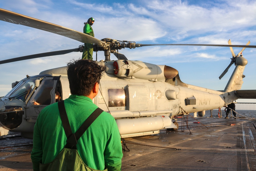AESA Bruce Wade and AM2 Keith Gonzales conduct post flight rotor securing operations