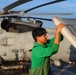 AM2 Keith Gonzales begins stowing an MH-60R Sea Hawk helicopter during the Northern Coasts