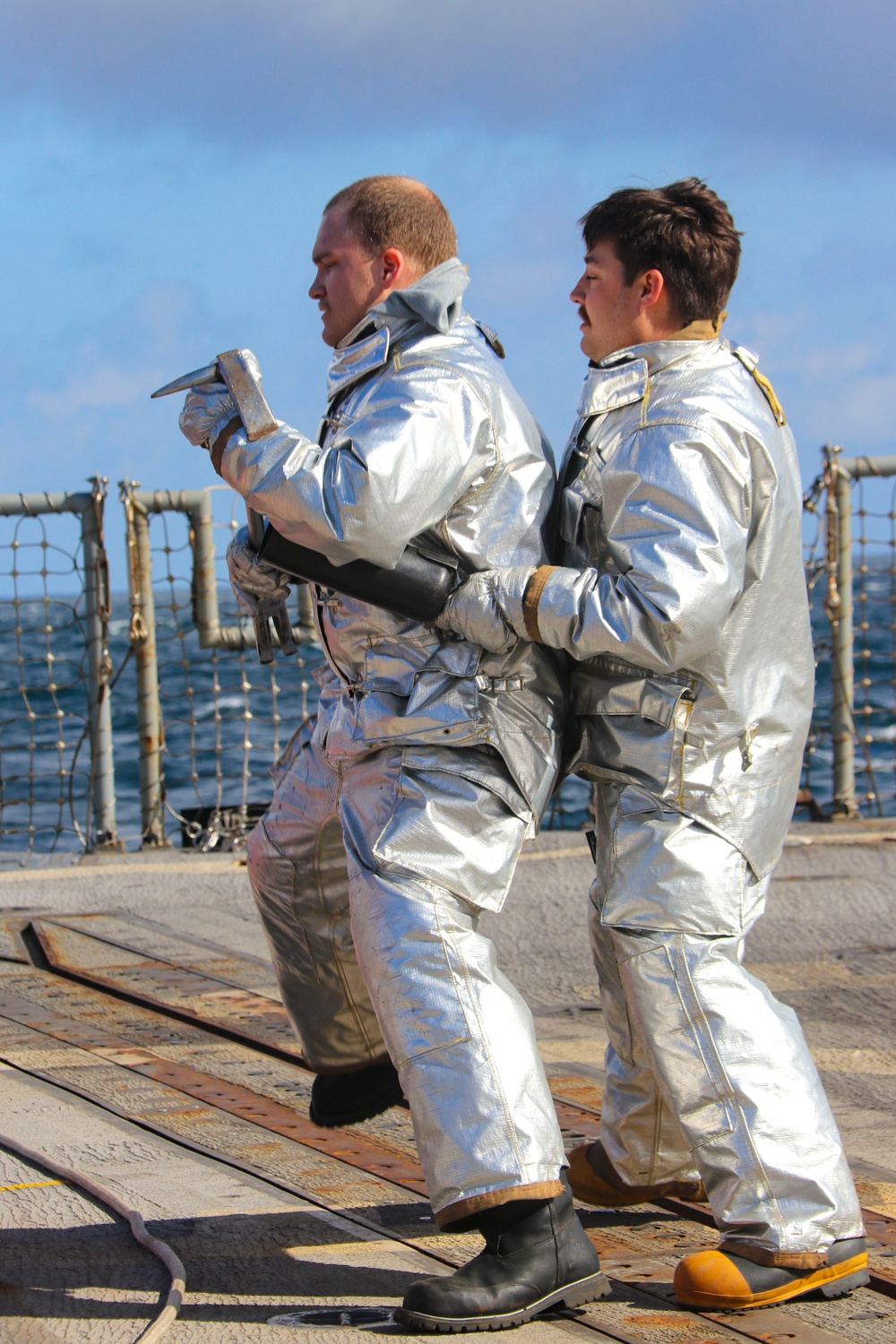DC3  Levi Nuslein and DC3 Nicholas Ewing conduct simulated crash and salvage training on the flight deck