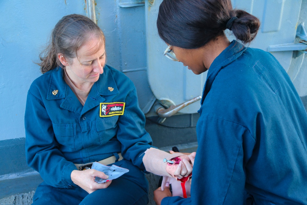 STGC Gloria Dibler and LS2 Desamoure Stanisha demonstrate medical treatment of personnel during a simulated mass casualty drill STGC Gloria Dibler and LS2 Desamoure Stanisha demonstrate medical treatment of personnel during a simulated mass casualty drill