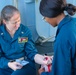STGC Gloria Dibler and LS2 Desamoure Stanisha demonstrate medical treatment of personnel during a simulated mass casualty drill