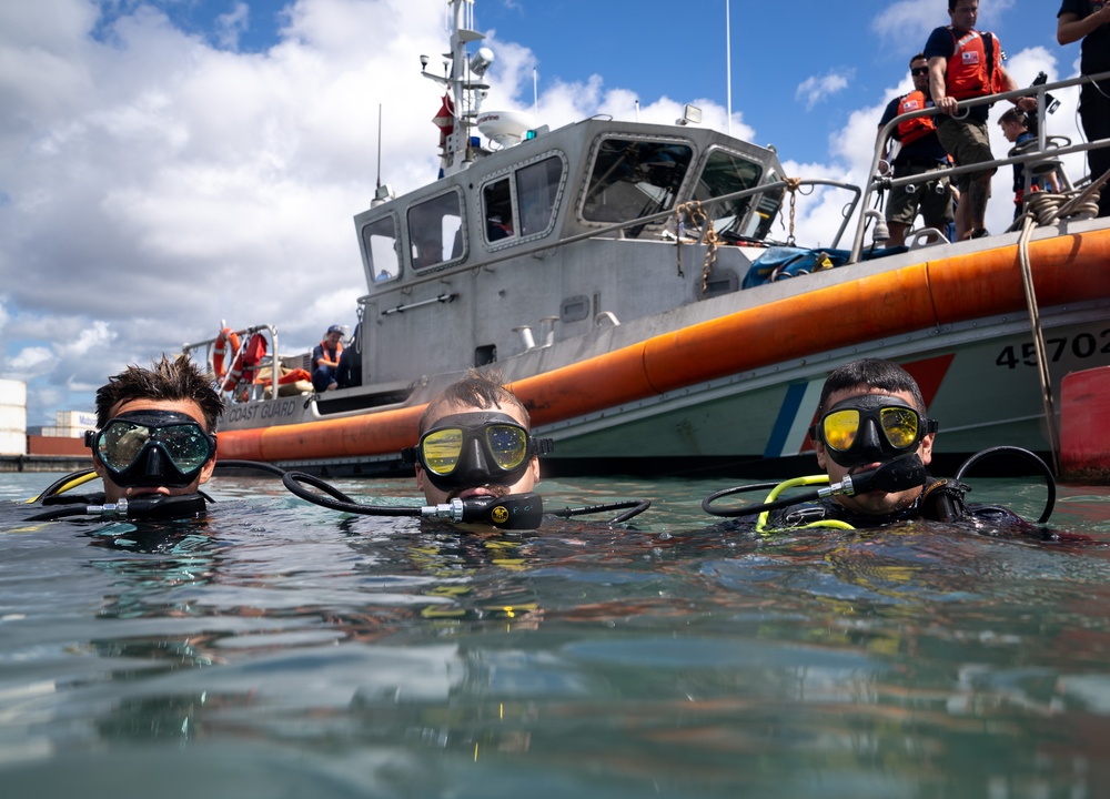 U.S. Coast Guard divers conduct aids to navigation maintenance