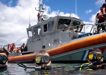 U.S. Coast Guard divers conduct aids to navigation maintenance