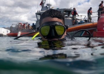 U.S. Coast Guard divers conduct aids to navigation maintenance