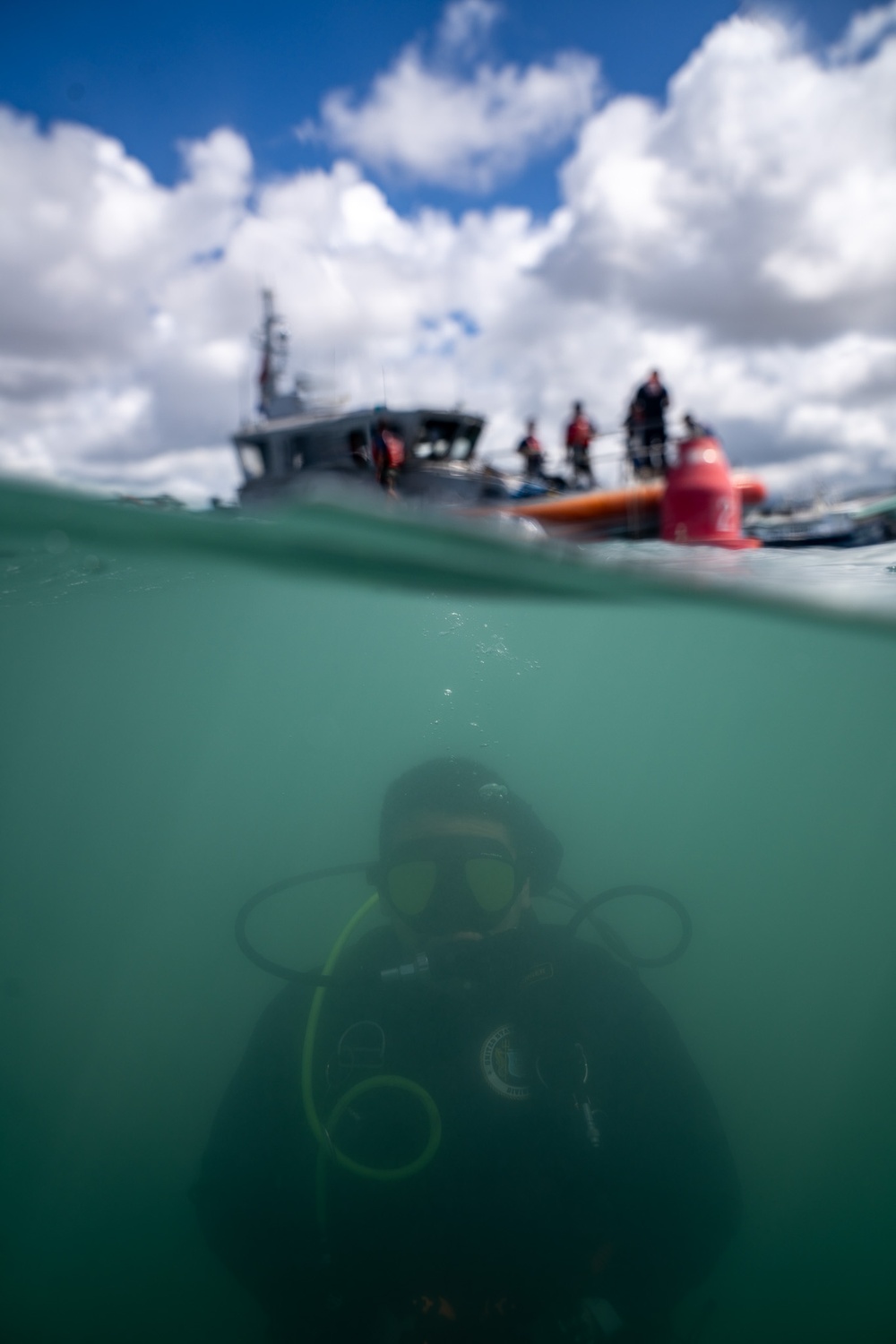 U.S. Coast Guard divers conduct aids to navigation maintenance