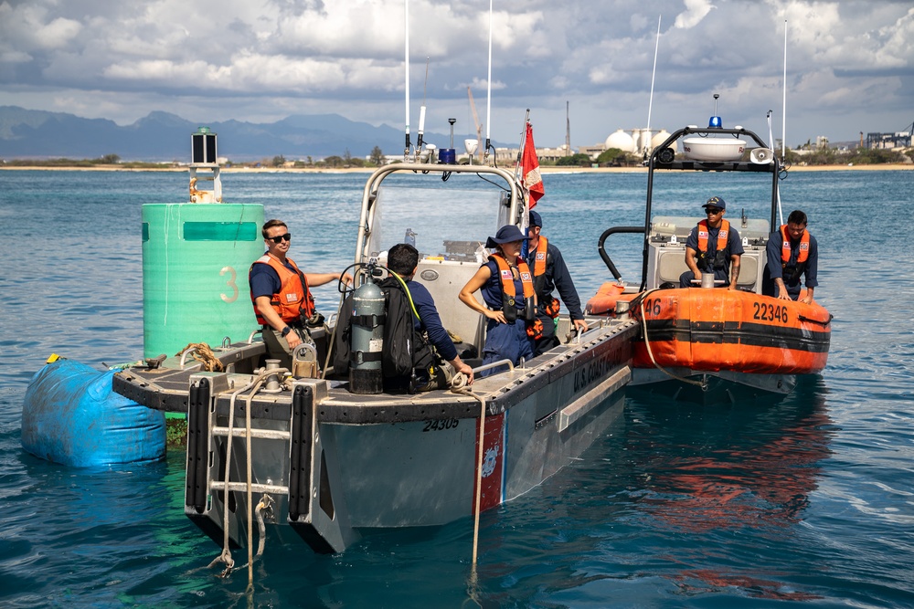 U.S. Coast Guard Cutter Juniper conducts maintenance on channel buoys