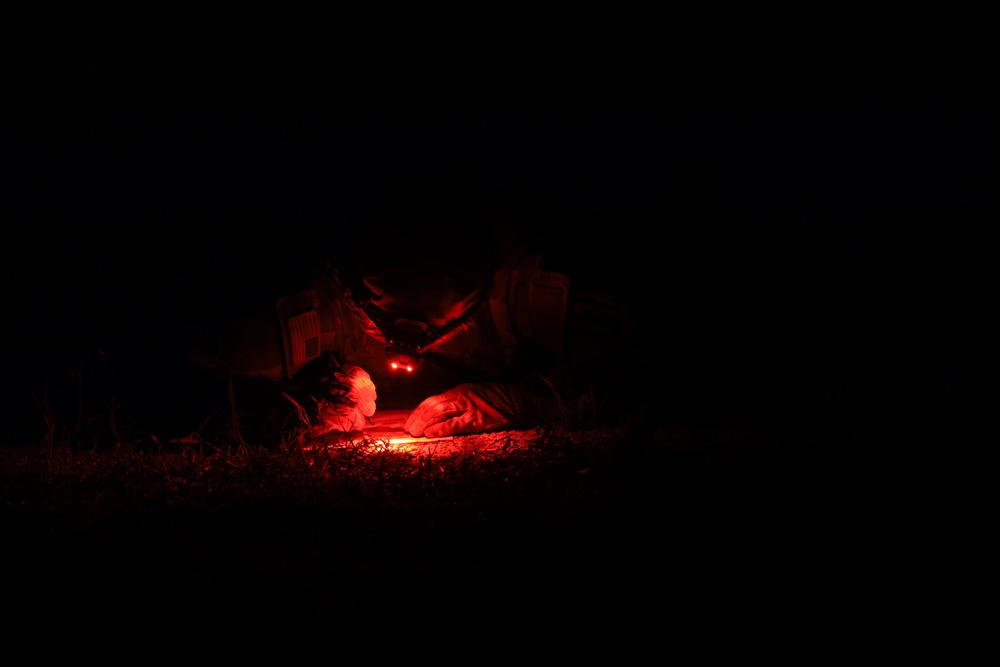 U.S. Soldier Checks Map During Night Land Navigation