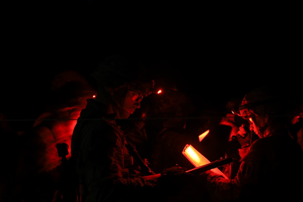 Soldiers conduct night land navigation in pursuit of U.S. Army Expert Badges