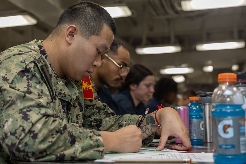 Sailors take the E-5 examination on board USS Iwo Jima (LHD 7)
