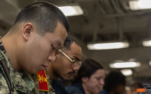 Sailors take the E-5 examination on board USS Iwo Jima (LHD 7)