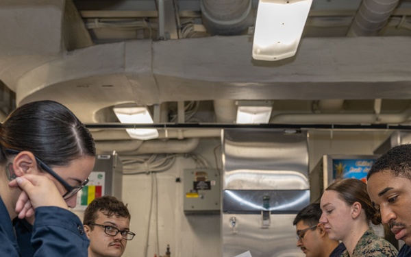 Sailors take the E-5 examination on board USS Iwo Jima (LHD 7)