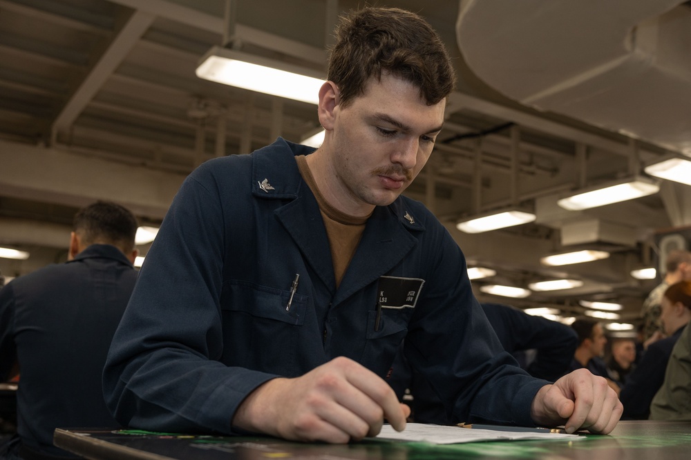 Sailors take the E-5 examination on board USS Iwo Jima (LHD 7)