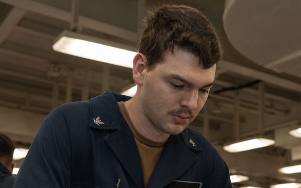 Sailors take the E-5 examination on board USS Iwo Jima (LHD 7)