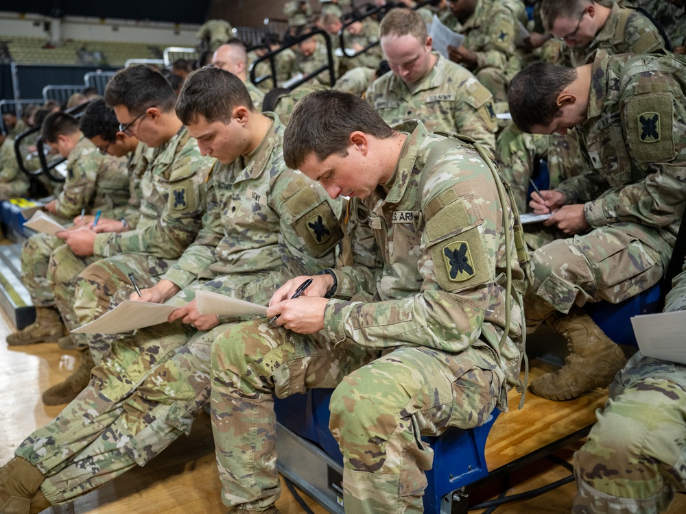 Soldiers with the 256th Infantry Brigade Combat Team receive an initial briefing and are sworn in for deputization