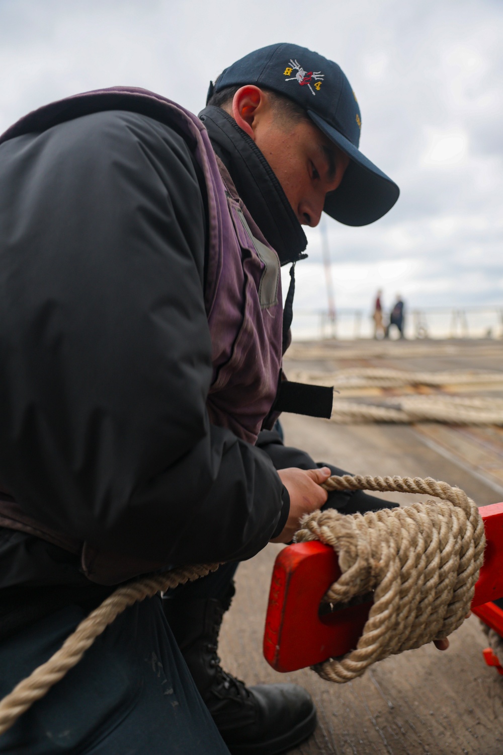 FC2 Eddie Hernandezmota stows the pilot ladder on the flight deck