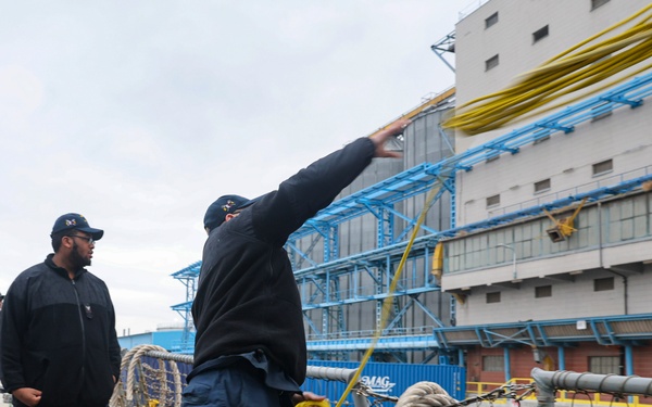 USS Bulekley (DDG 84) Sailors toss a heaving line to a pier side line-handler