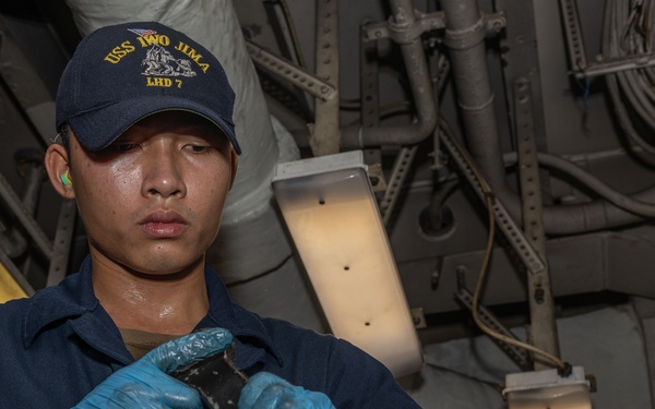 USS Iwo Jima (LHD 7) Sailor Assembles a Burner Barrel