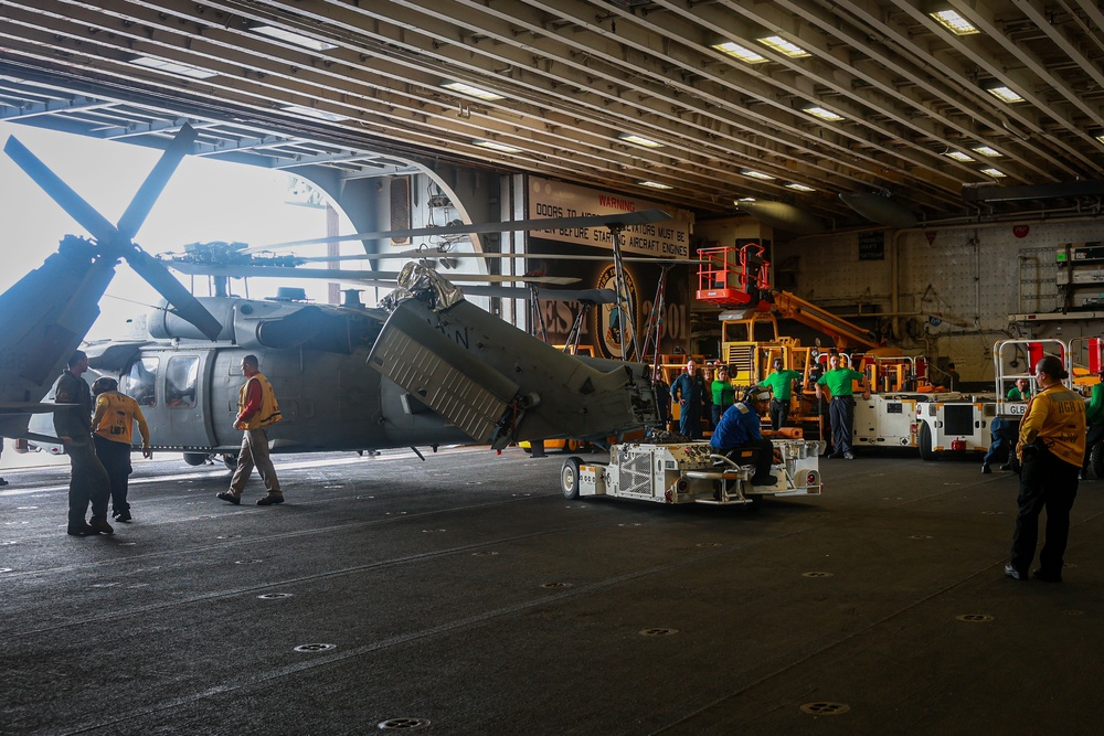 USS Iwo Jima Sailors move a MH-60S Seahawk