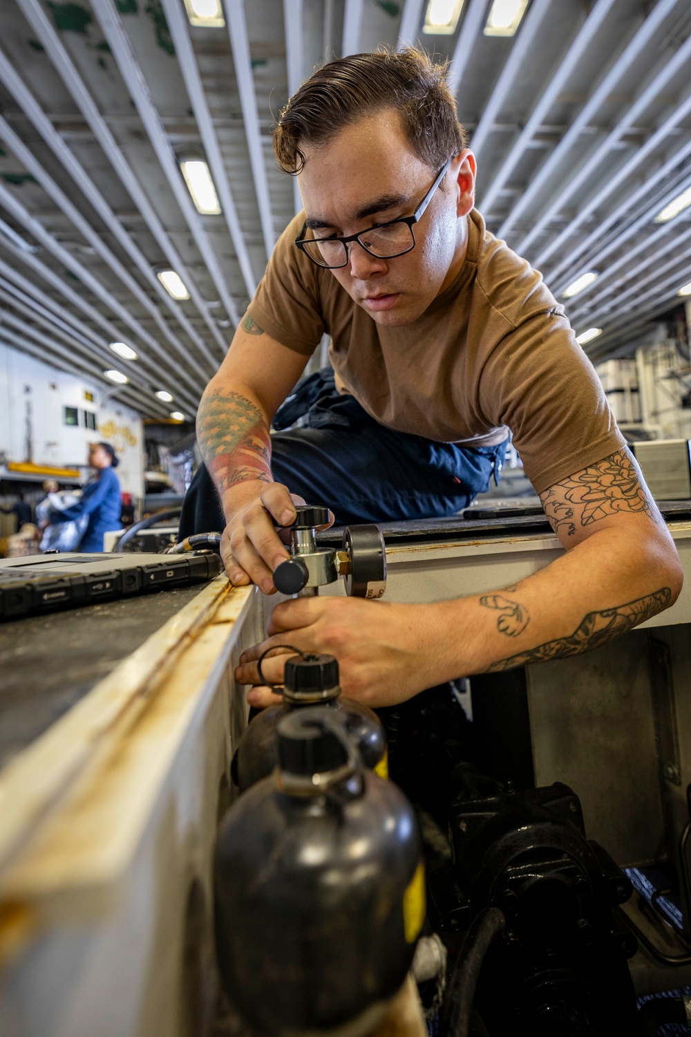 USS Iwo Jima Sailor Maintains Aircraft Equipment
