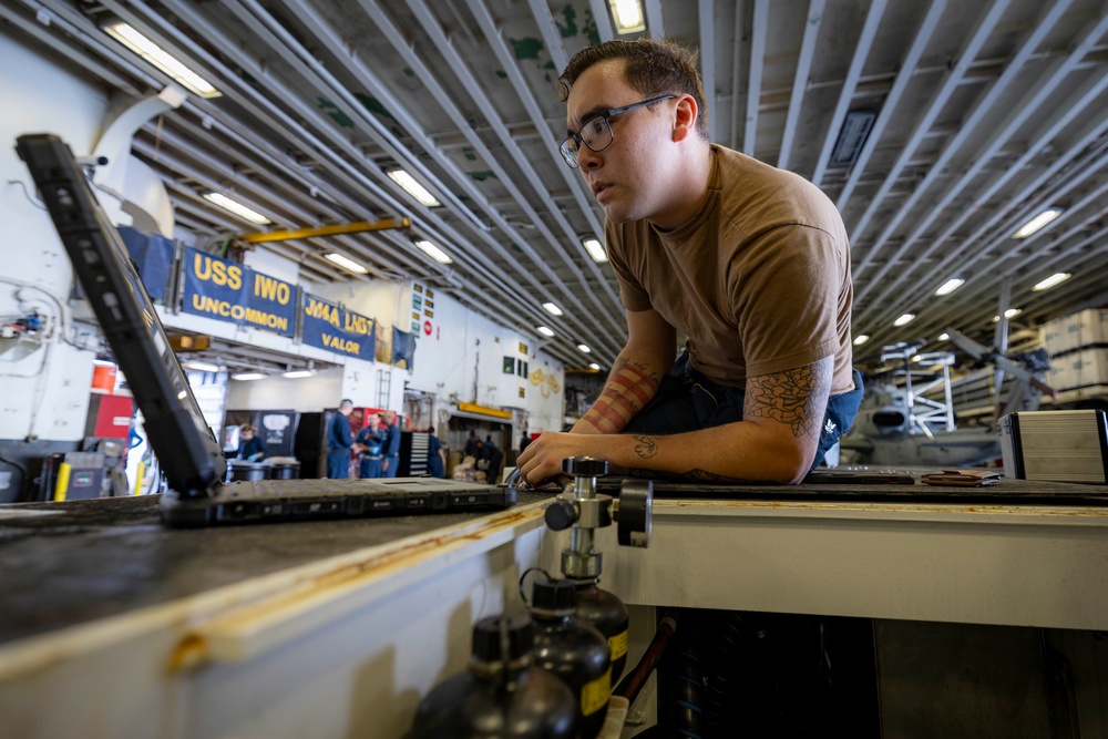 USS Iwo Jima Sailor Maintains Aircraft Equipment