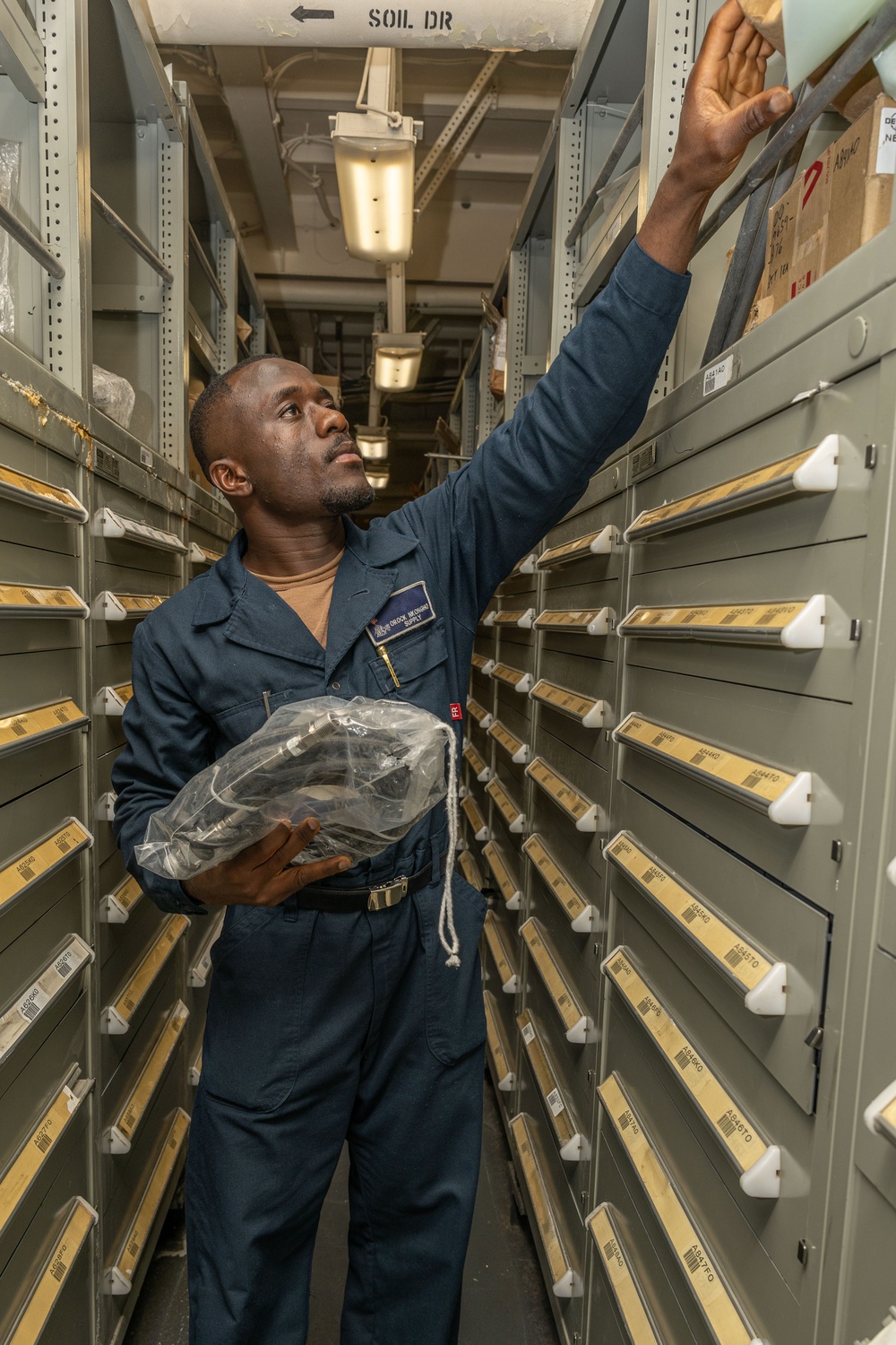 USS Iwo Jima Sailors Audits A Supply Room