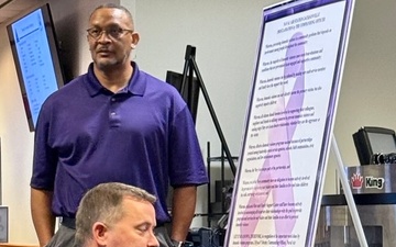 Naval Air Station Jacksonville Commanding Officer signs proclamation for Domestic Violence Awareness month.