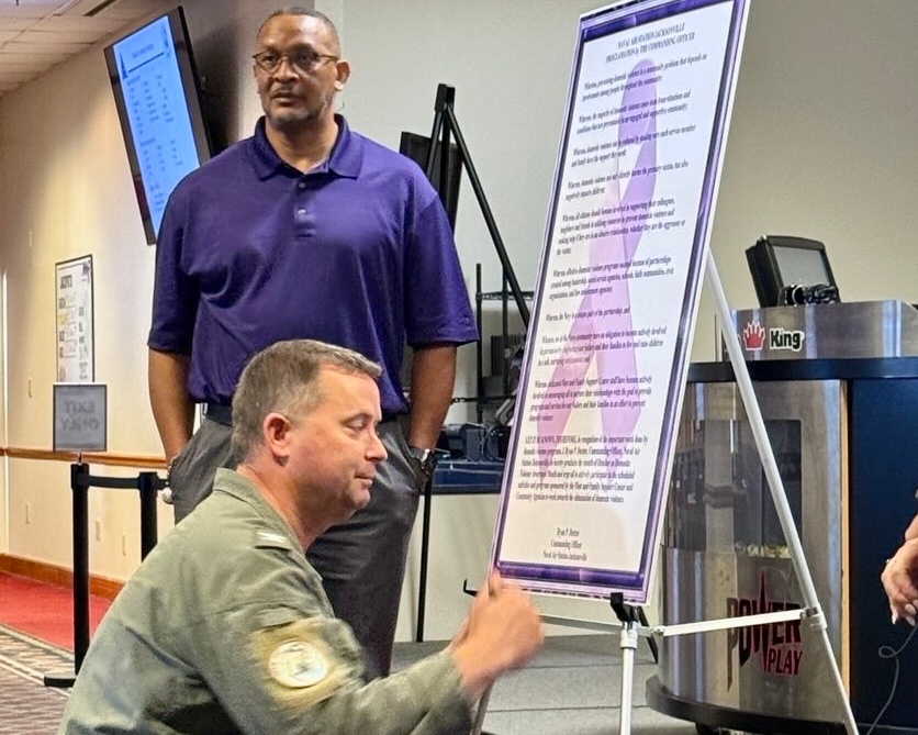 Naval Air Station Jacksonville Commanding Officer signs proclamation for Domestic Violence Awareness month.