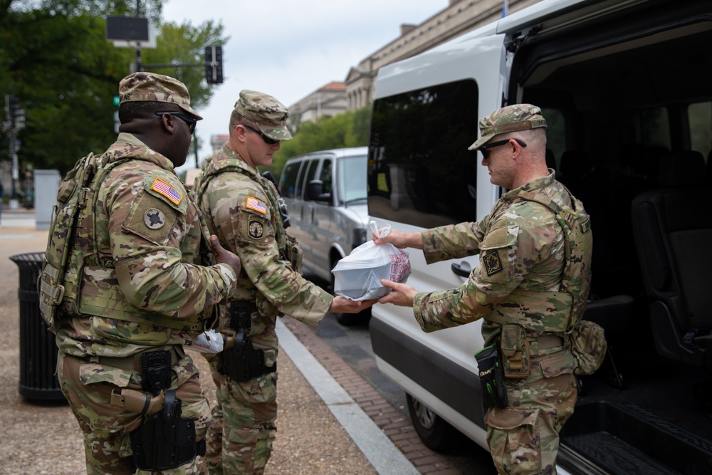 Mississippi National Guard Soldiers receive food while on patrol in Washington, D.C.