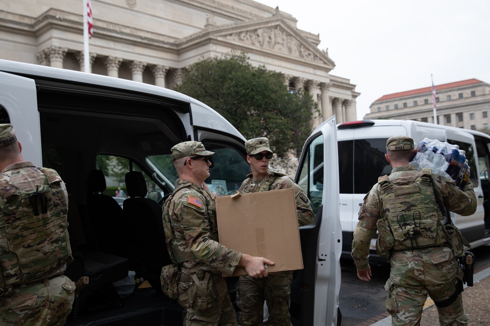Mississippi National Guard Soldiers deliver food in front of the National Archives Building