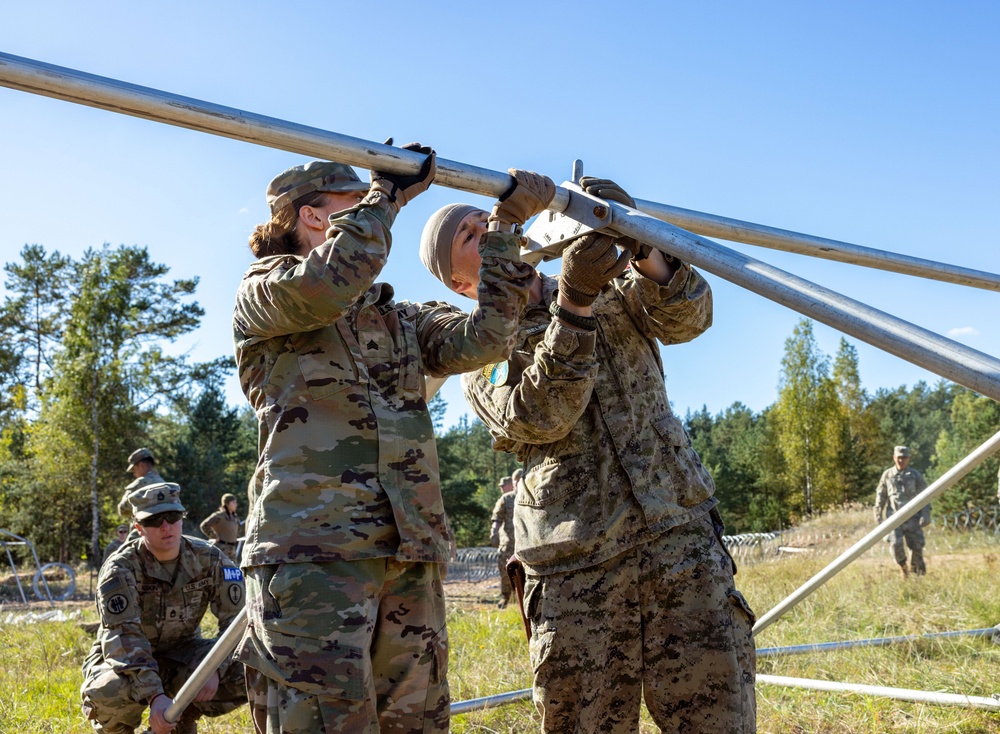 Military Police forces from U.S. and Canada train together to build detainee holding areas Military Police forces from U.S. and Canada train together to build detainee holding areas