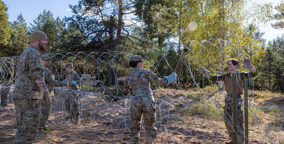 Military Police forces from U.S. and Canada train together to build detainee holding areas Military Police forces from U.S. and Canada train together to build detainee holding areas