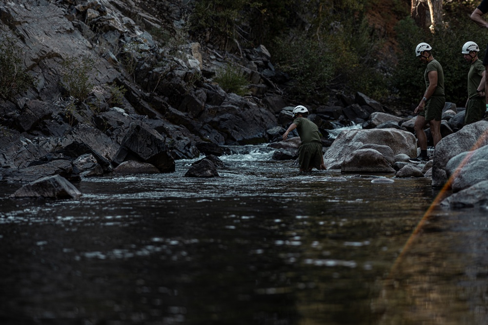 U.S. service members and German soldiers conduct stream crossing exercises during Mountain Medicine 3-25 
