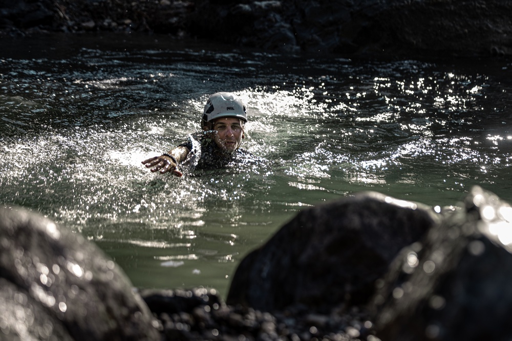 U.S. service members and German soldiers conduct stream crossing exercises during Mountain Medicine 3-25 