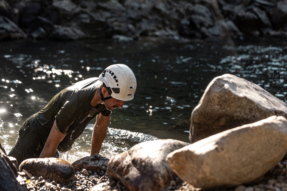 U.S. service members and German soldiers conduct stream crossing exercises during Mountain Medicine 3-25 
