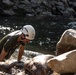 U.S. service members and German soldiers conduct stream crossing exercises during Mountain Medicine 3-25 