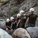 U.S. service members and German soldiers conduct stream crossing exercises during Mountain Medicine 3-25 