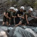 U.S. service members and German soldiers conduct stream crossing exercises during Mountain Medicine 3-25 