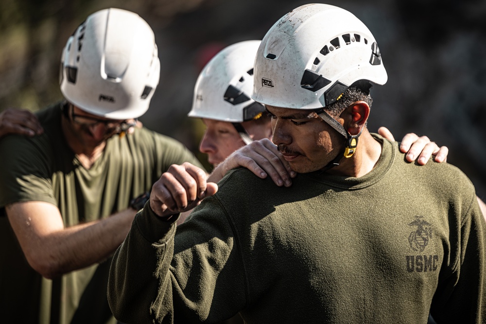 U.S. service members and German soldiers conduct stream crossing exercises during Mountain Medicine 3-25 