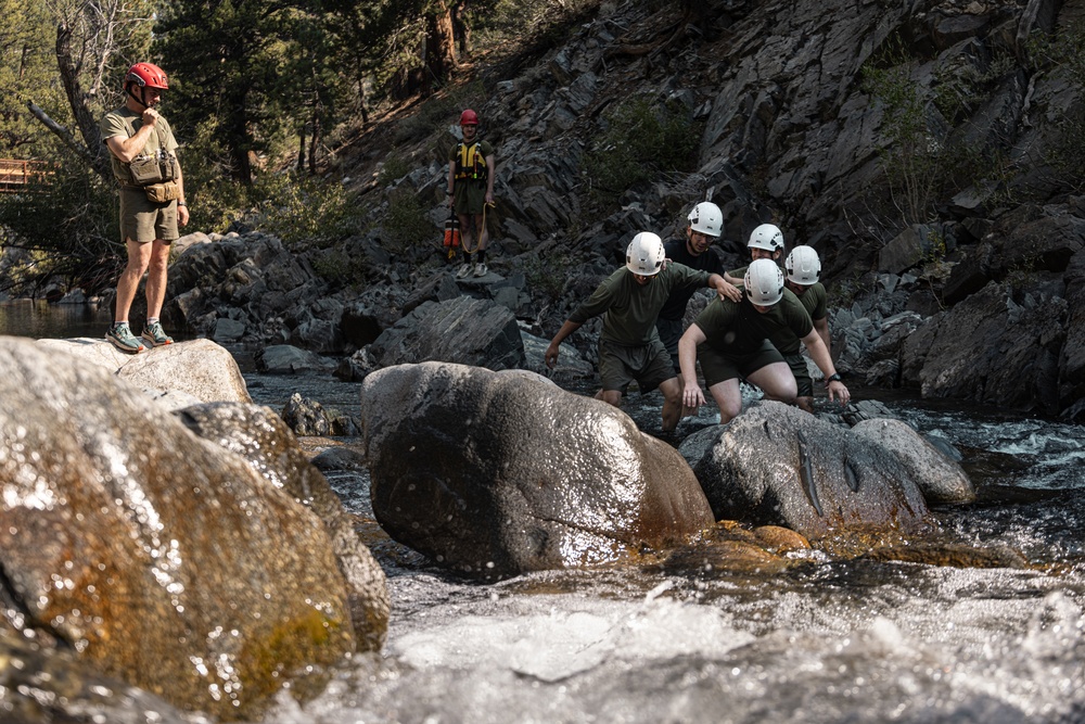 U.S. service members and German soldiers conduct stream crossing exercises during Mountain Medicine 3-25 