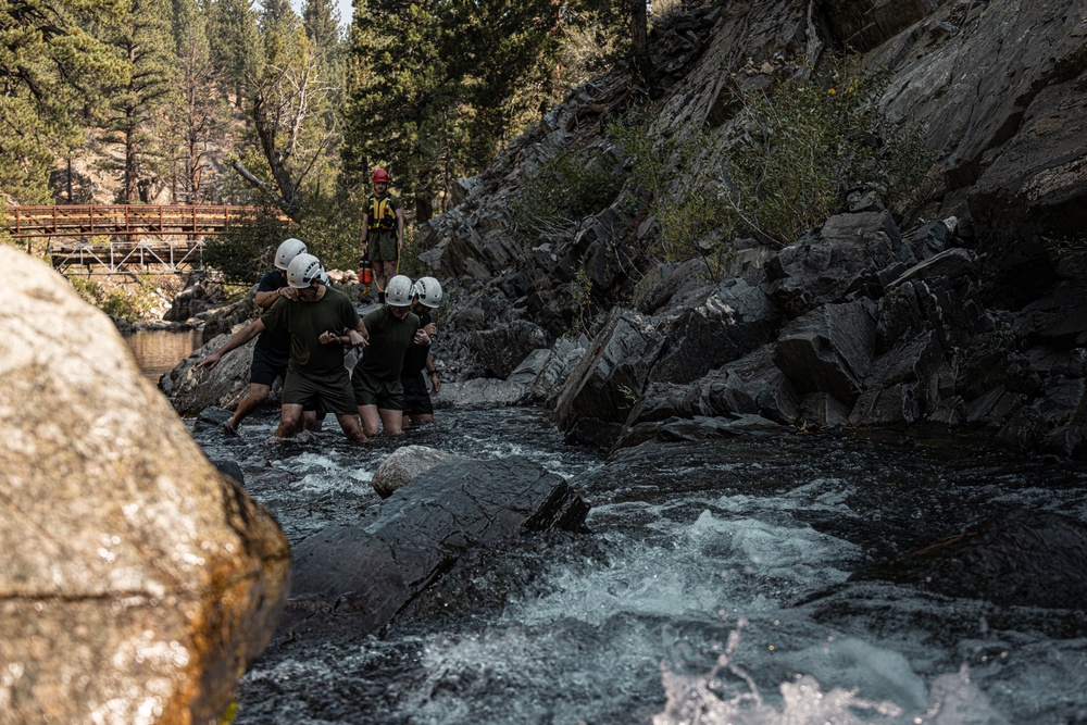 U.S. service members and German soldiers conduct stream crossing exercises during Mountain Medicine 3-25 