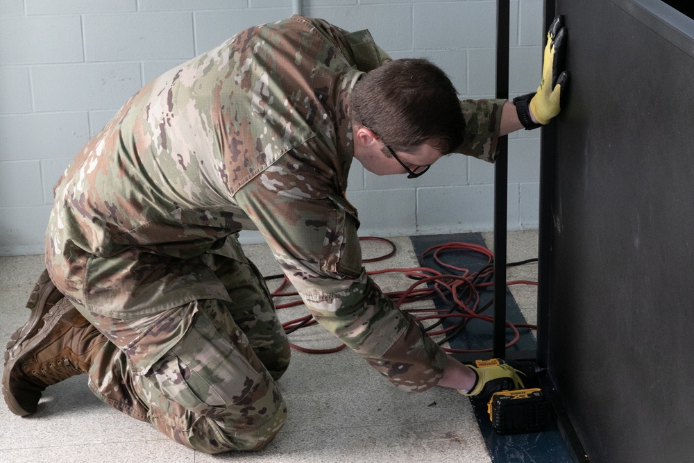 National Guardsmen remove old furniture and build new furniture for Capital Guardian Youth ChalleNGe Academy