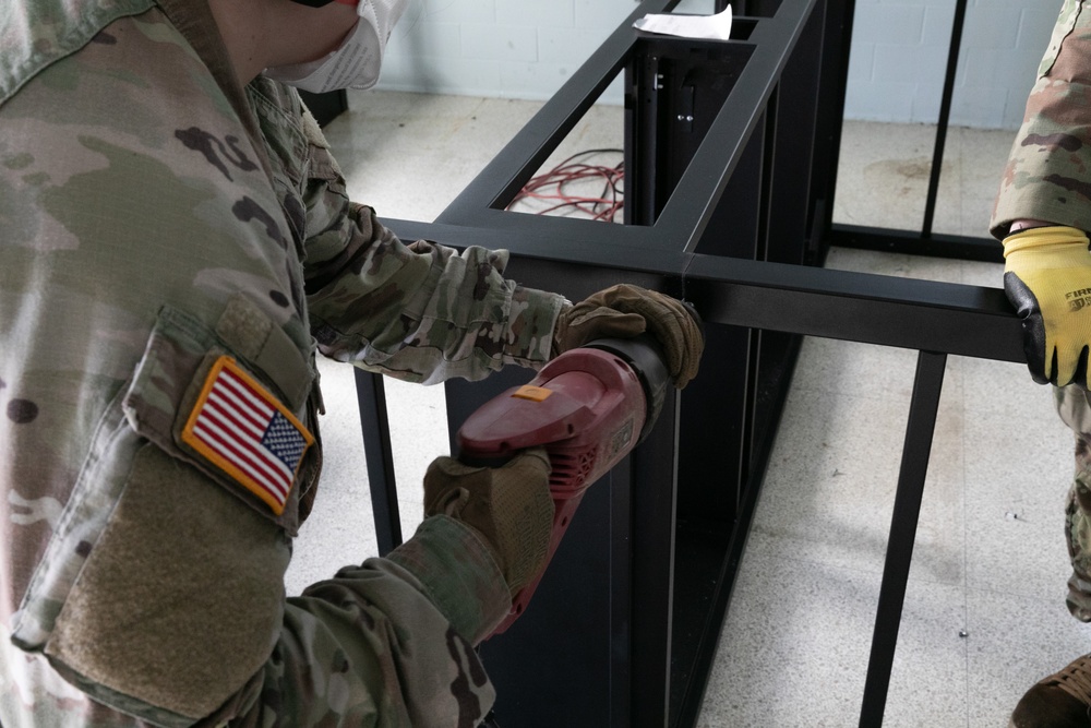 National Guardsmen remove old furniture and build new furniture for Capital Guardian Youth ChalleNGe Academy