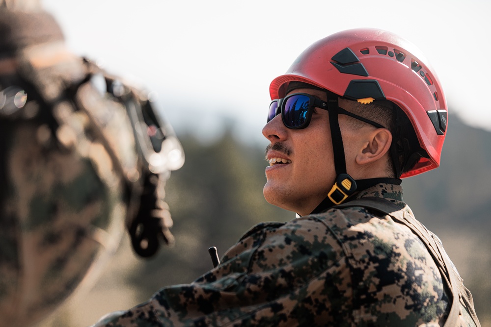 U.S. service members and German soldiers conduct repelling exercises during Mountain Medicine 3-25