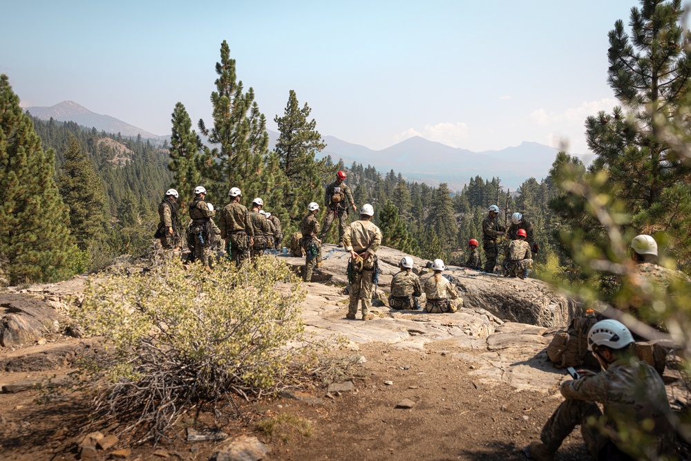 U.S. service members and German soldiers conduct repelling exercises during Mountain Medicine 3-25