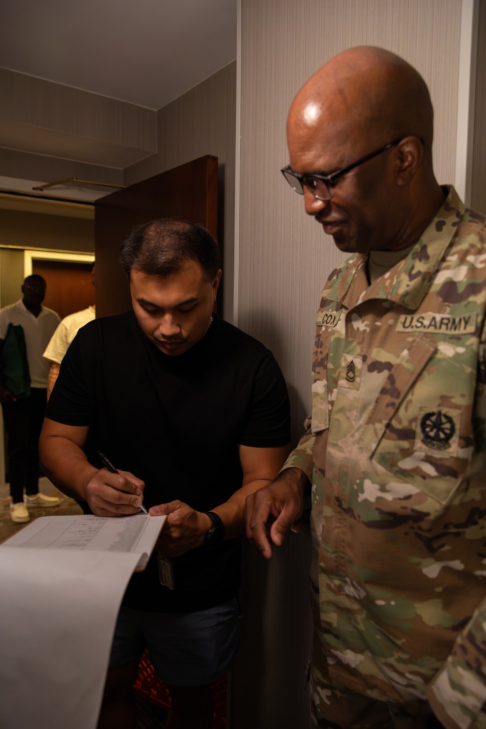 Mississippi National Guard Soldier signs for laundry bags