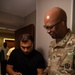 Mississippi National Guard Soldier signs for laundry bags