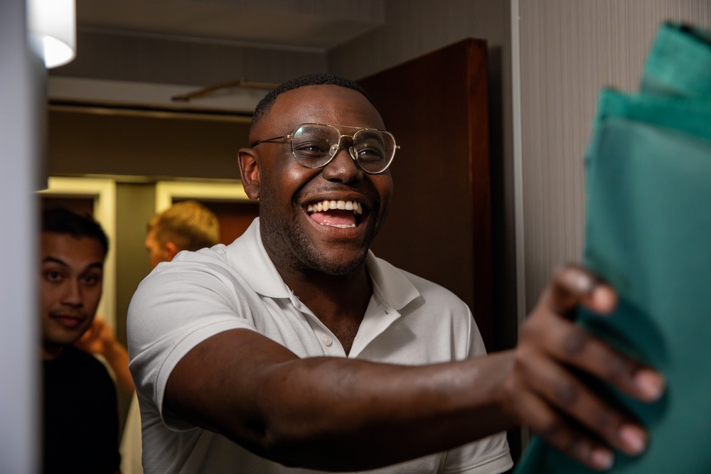 Mississippi National Guard Soldier smiles as he receives laundry bags