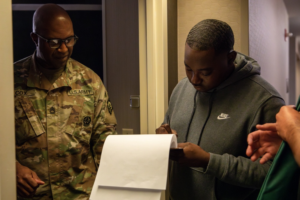 Mississippi National Guard Soldier signs for laundry bags after arriving to Washington, D.C.